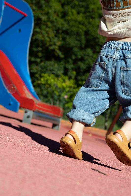 Simples Wonderskips in a playground setting showing a toddler walking on a rubber court surface
