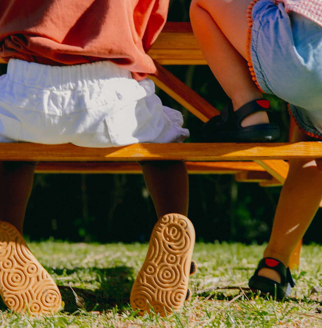 two children sitting on a bench
