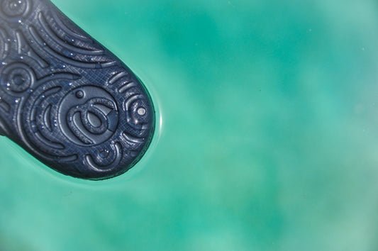Detailed view of the non-slip, high-traction tread pattern on the sole of a navy blue Wonderskips sandal.